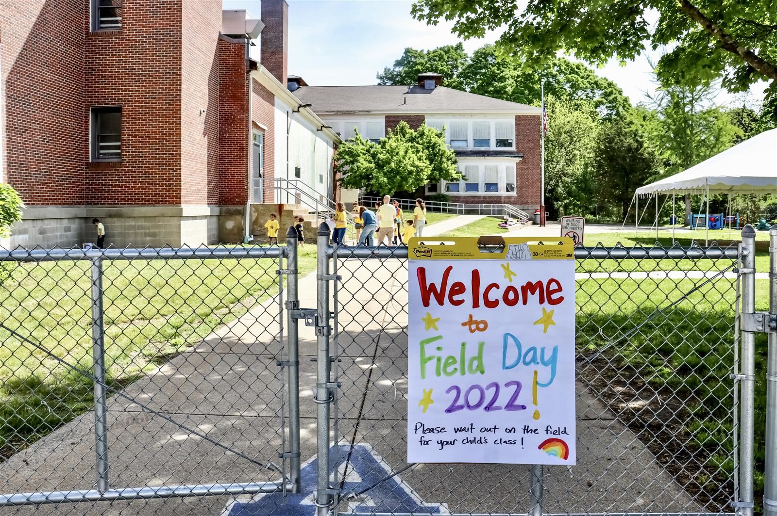 A colorful poster board sign reads Welcome to Field Day 2022! Please wait out on the field for your child's class!