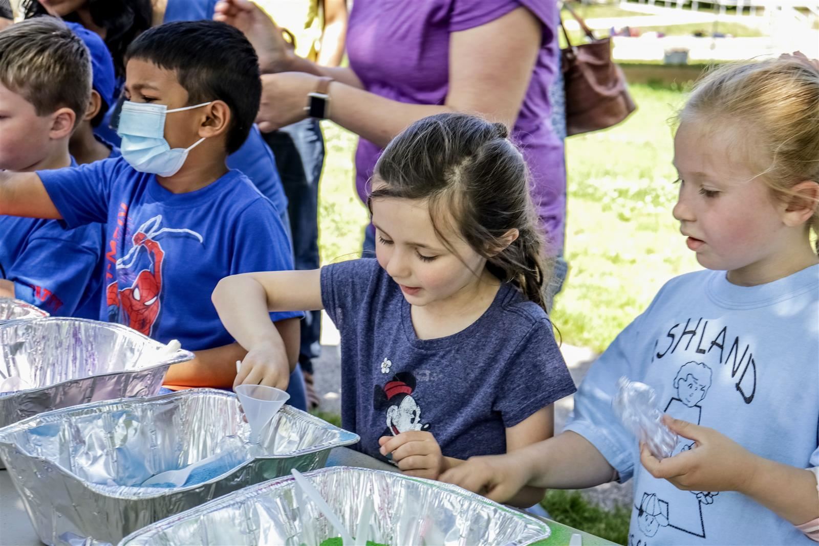 Ashland Preschool students play with sand at a craft table during a field day Ashland Preschool students play with sand at a craft table during a field day